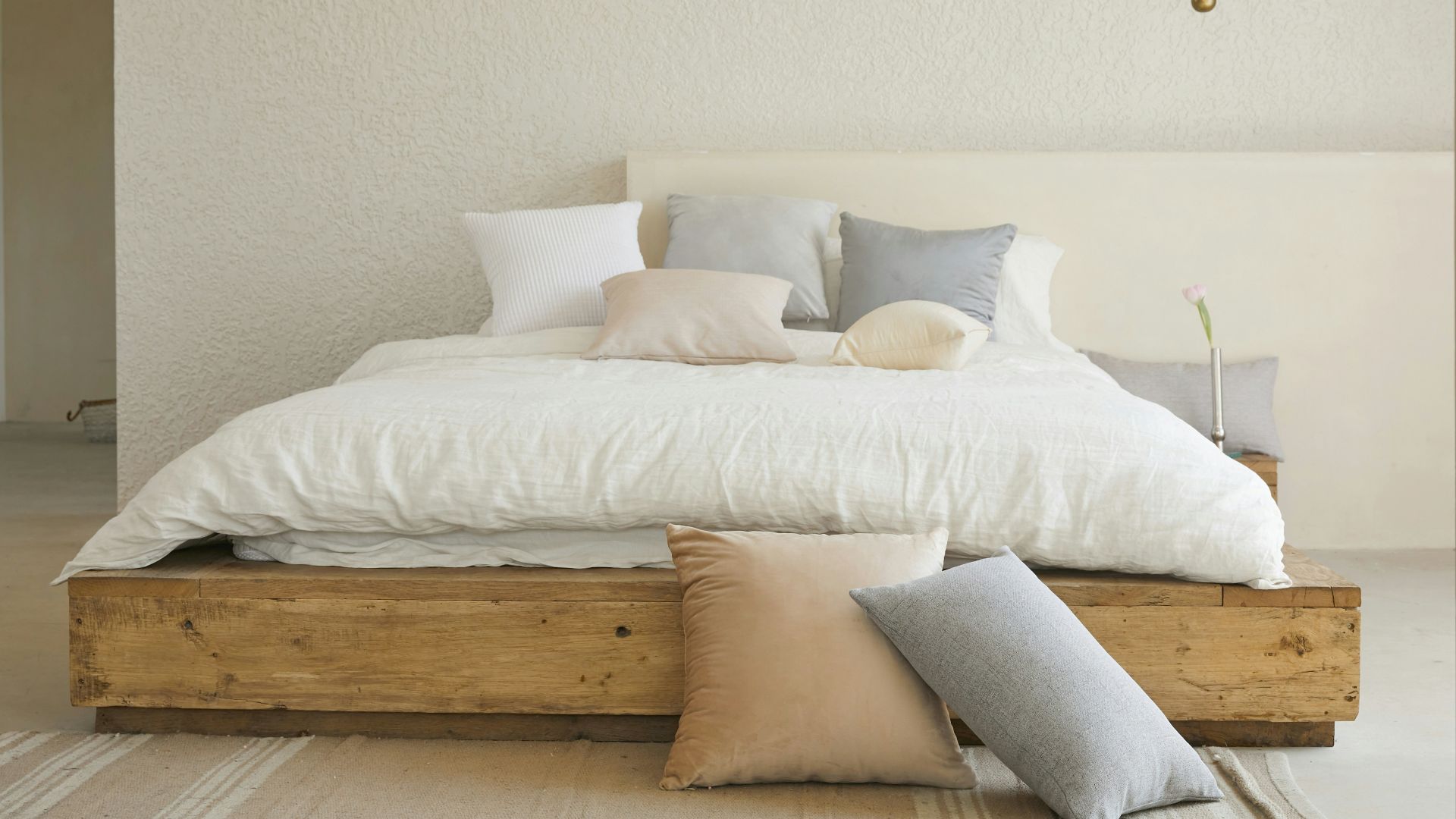 white bed pillow on brown wooden bed frame