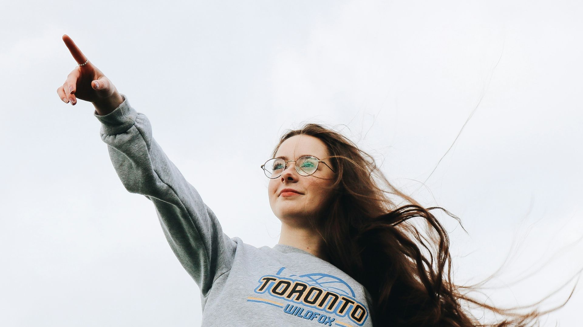 woman pointing using her right hand