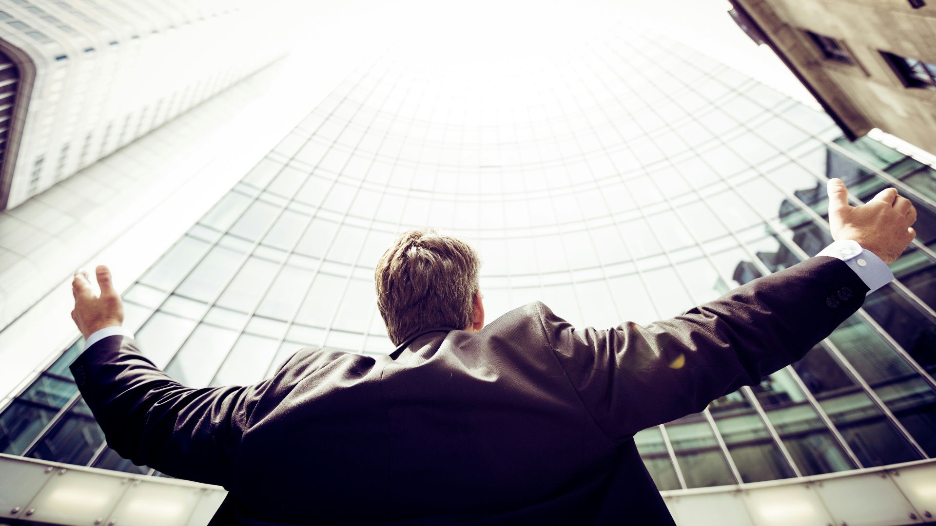 low-angle photography of man in the middle of buidligns