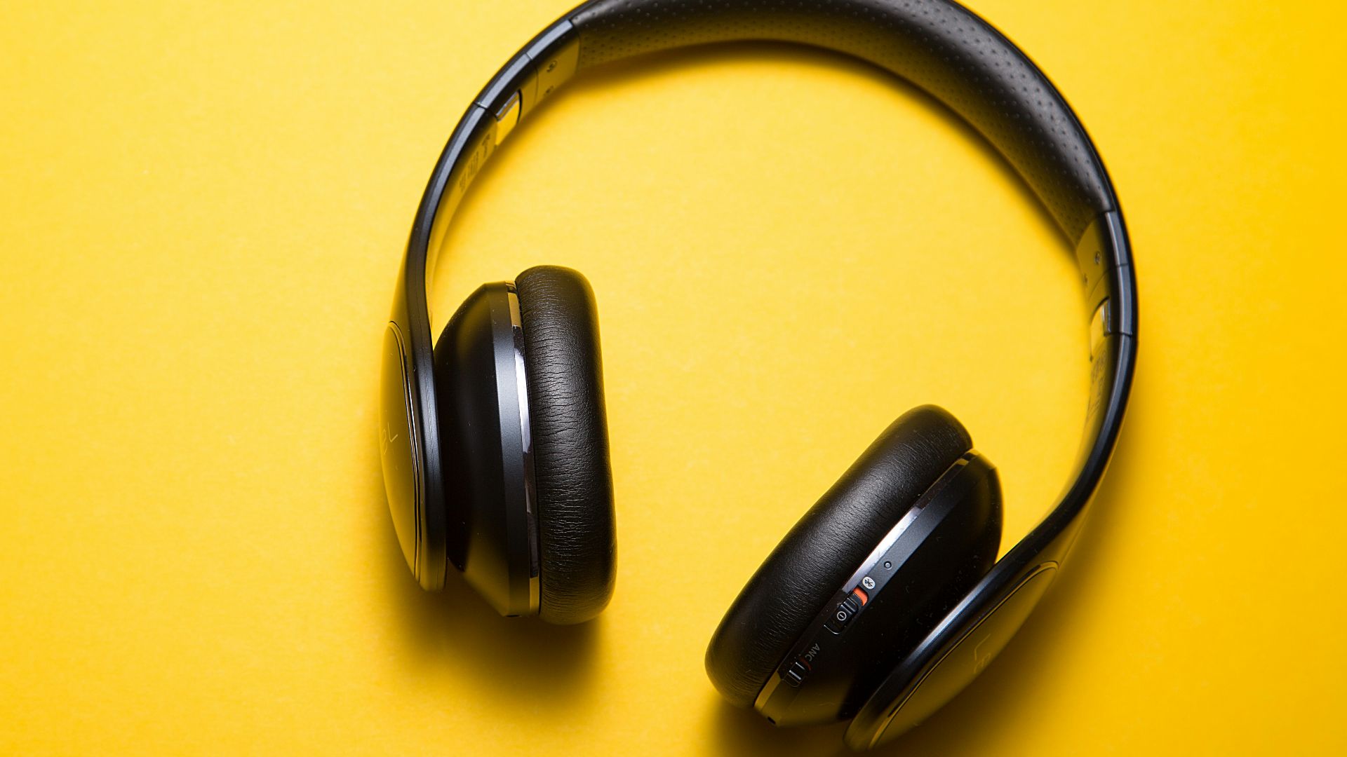 flatlay photography of wireless headphones