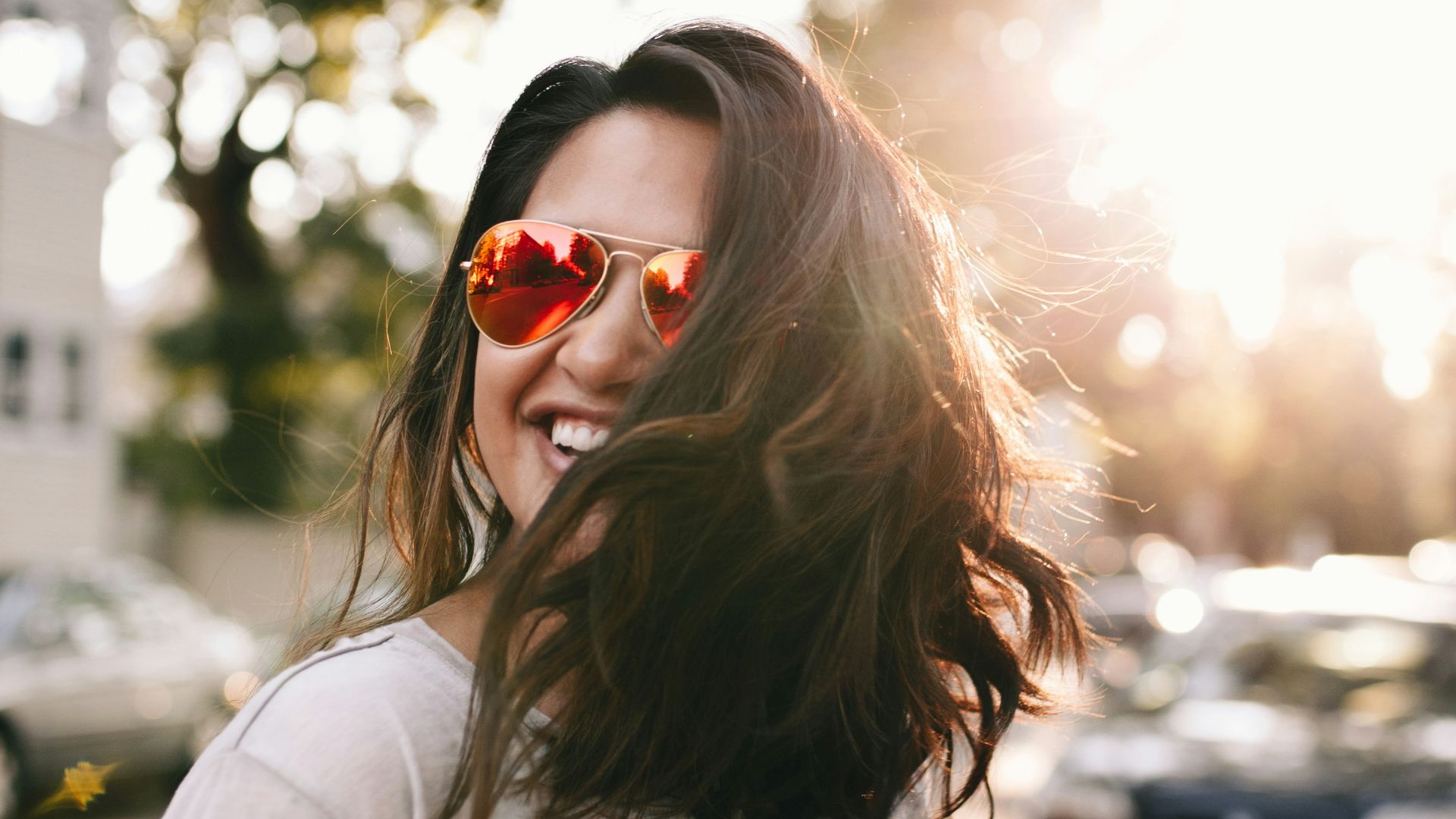 woman wearing white T-shirt smiling