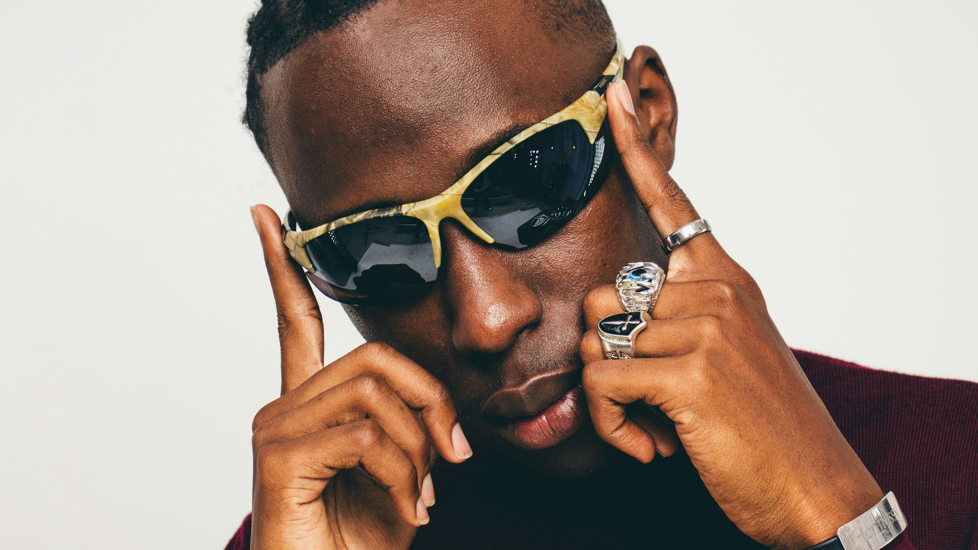 a man in a red sweater wearing sunglasses