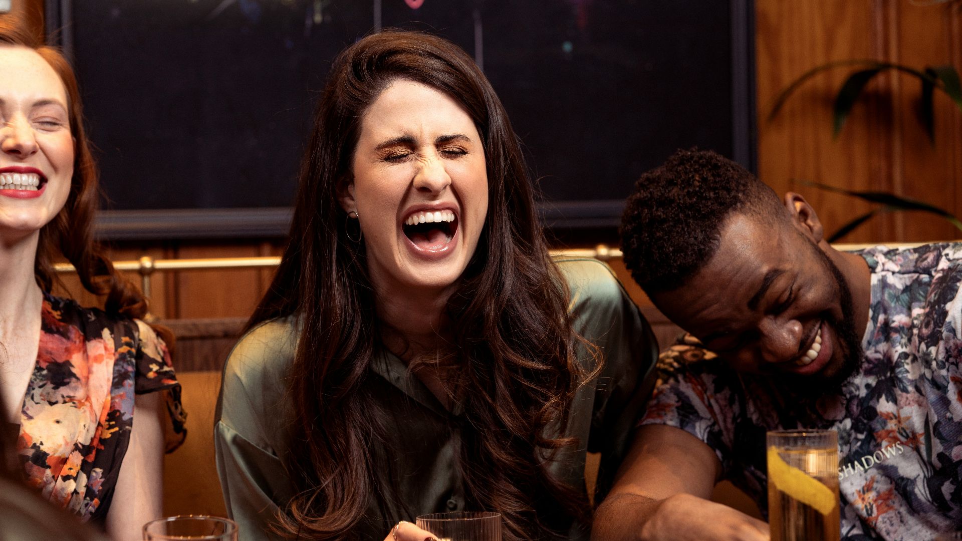 a group of people sitting around a table with drinks