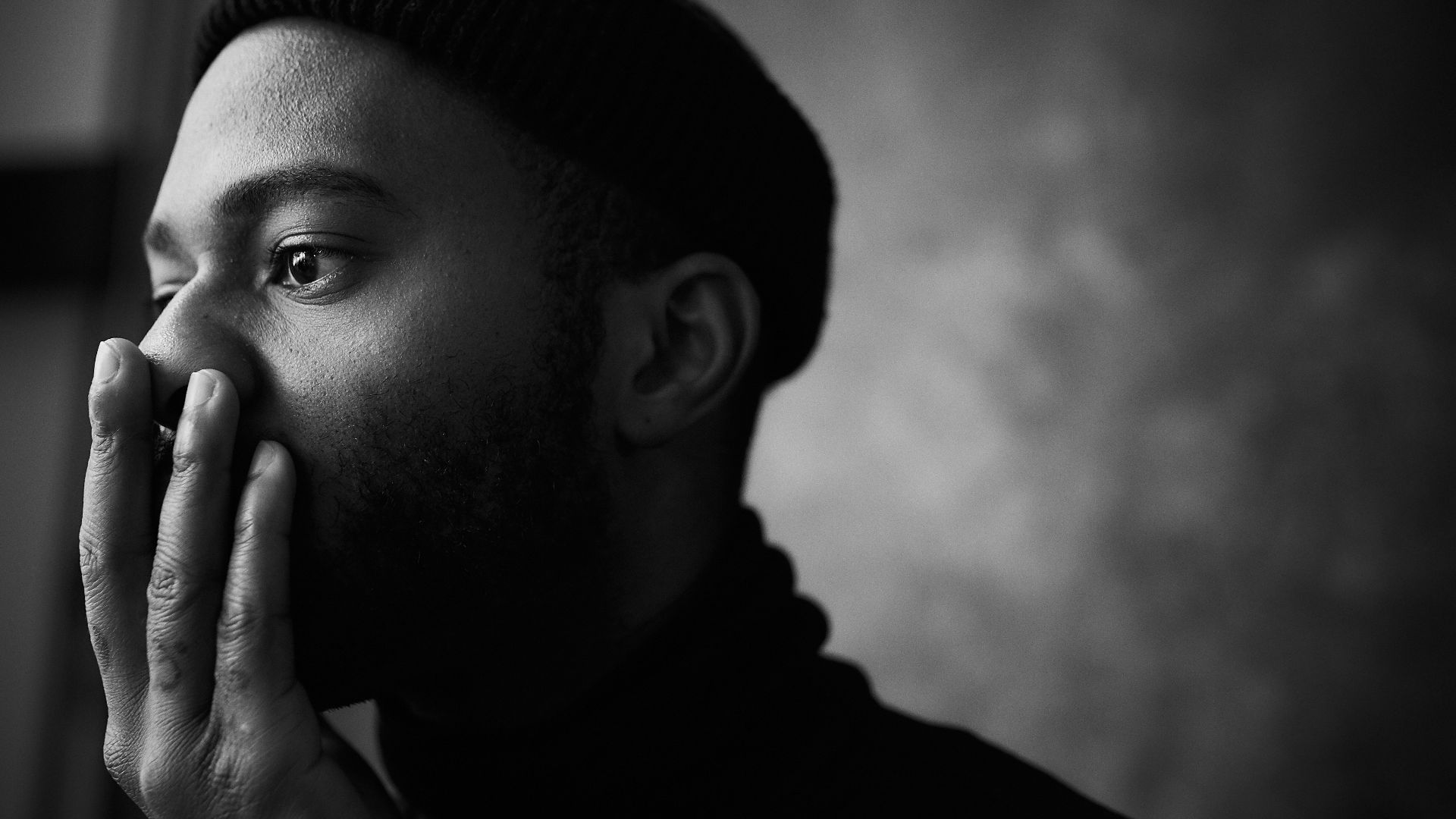 man in knit cap grayscale photo