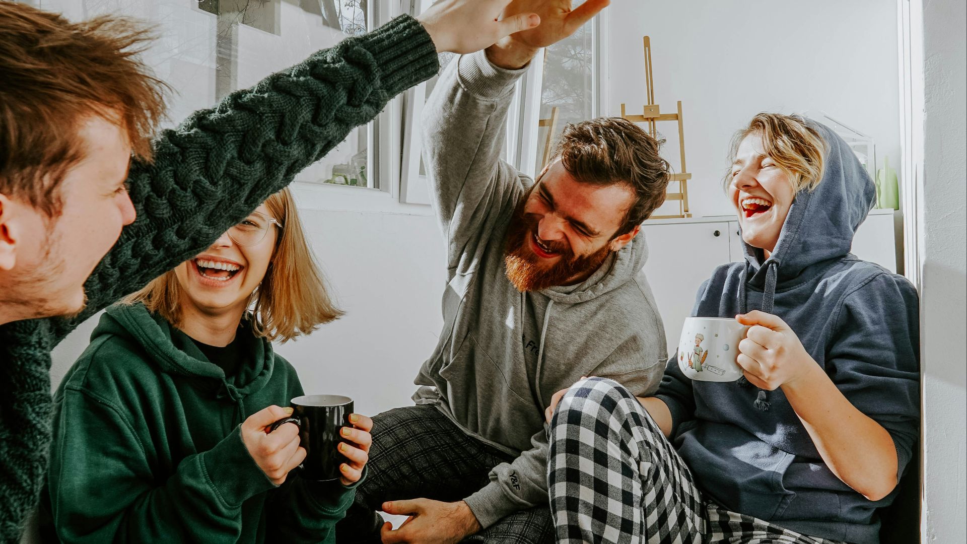 woman in black and white checkered long sleeve shirt sitting beside man in green crew neck