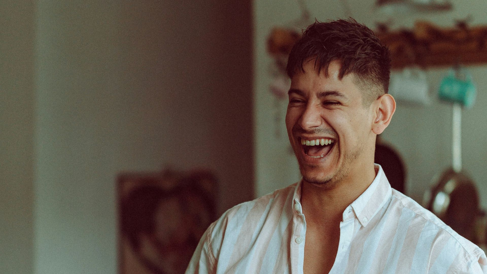 man in white dress shirt holding glass bottle