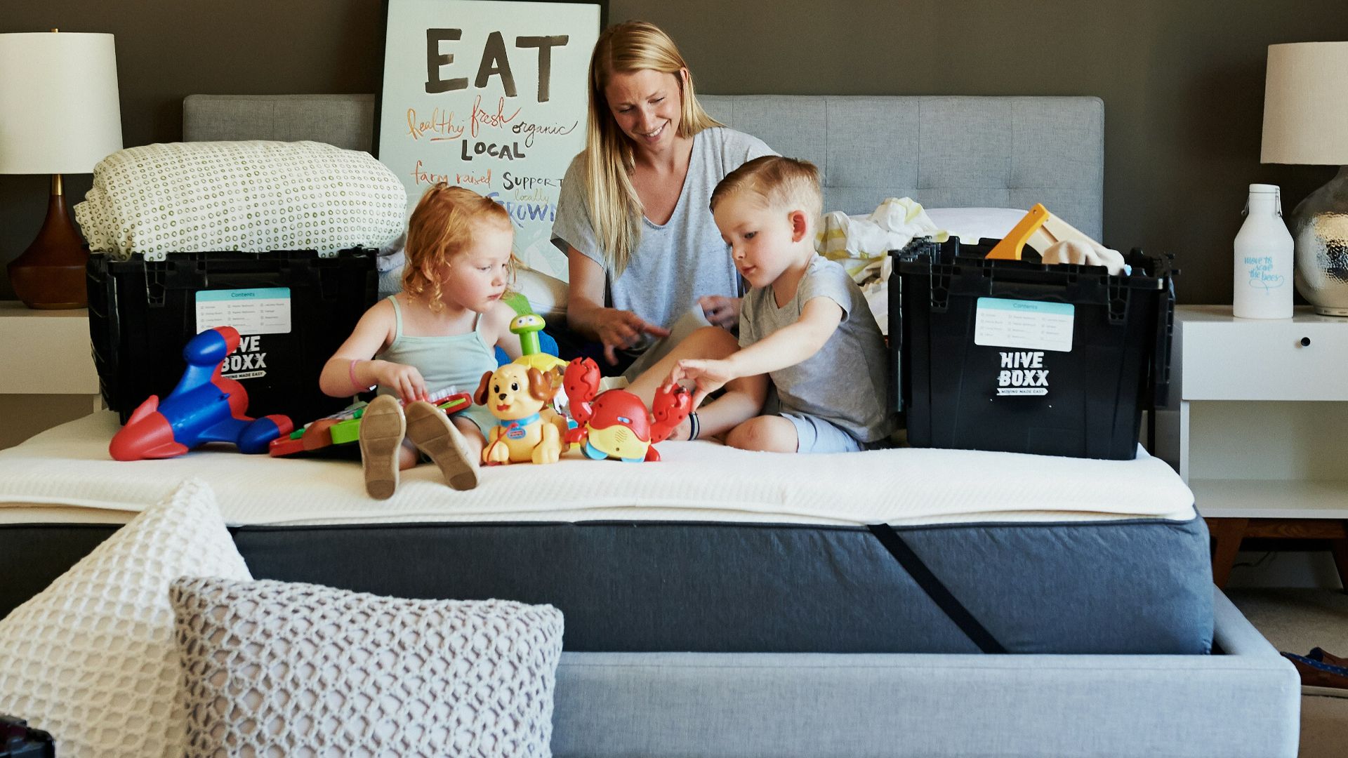 3 children sitting on gray couch