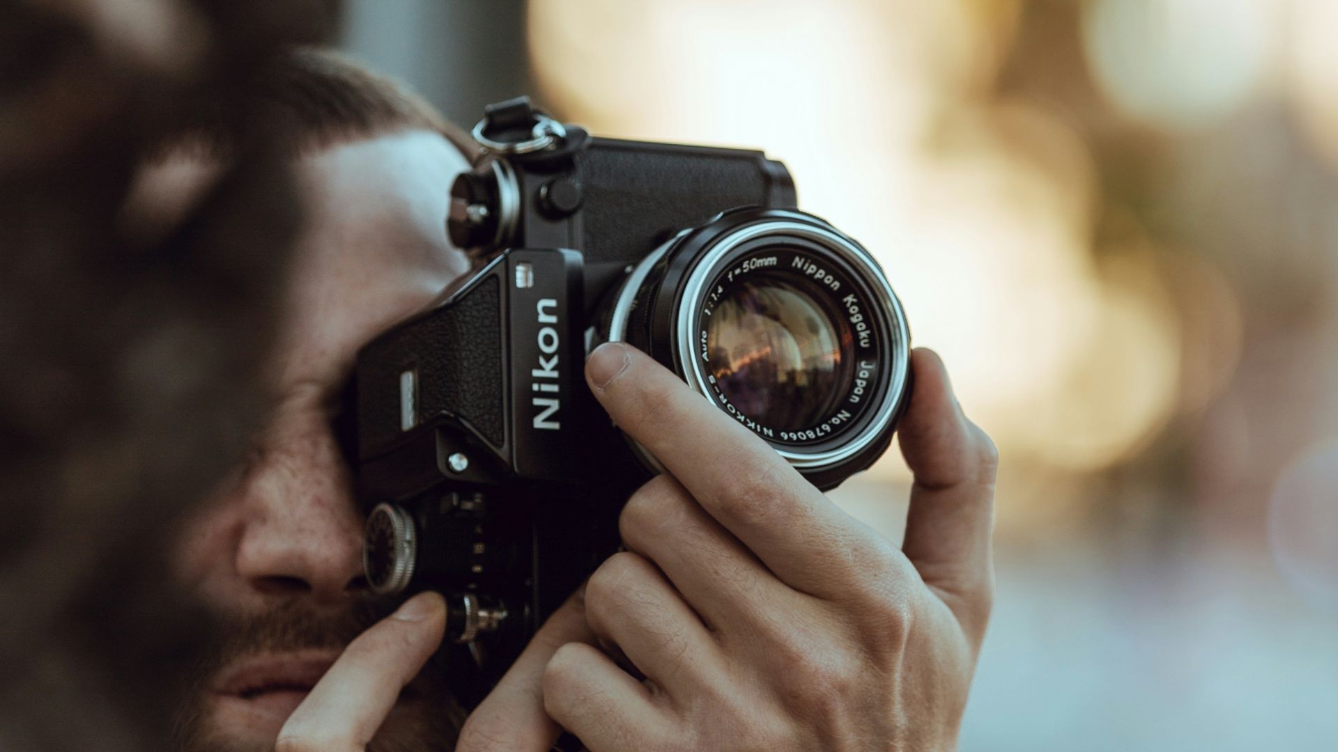 person using black Nikon DSLR camera