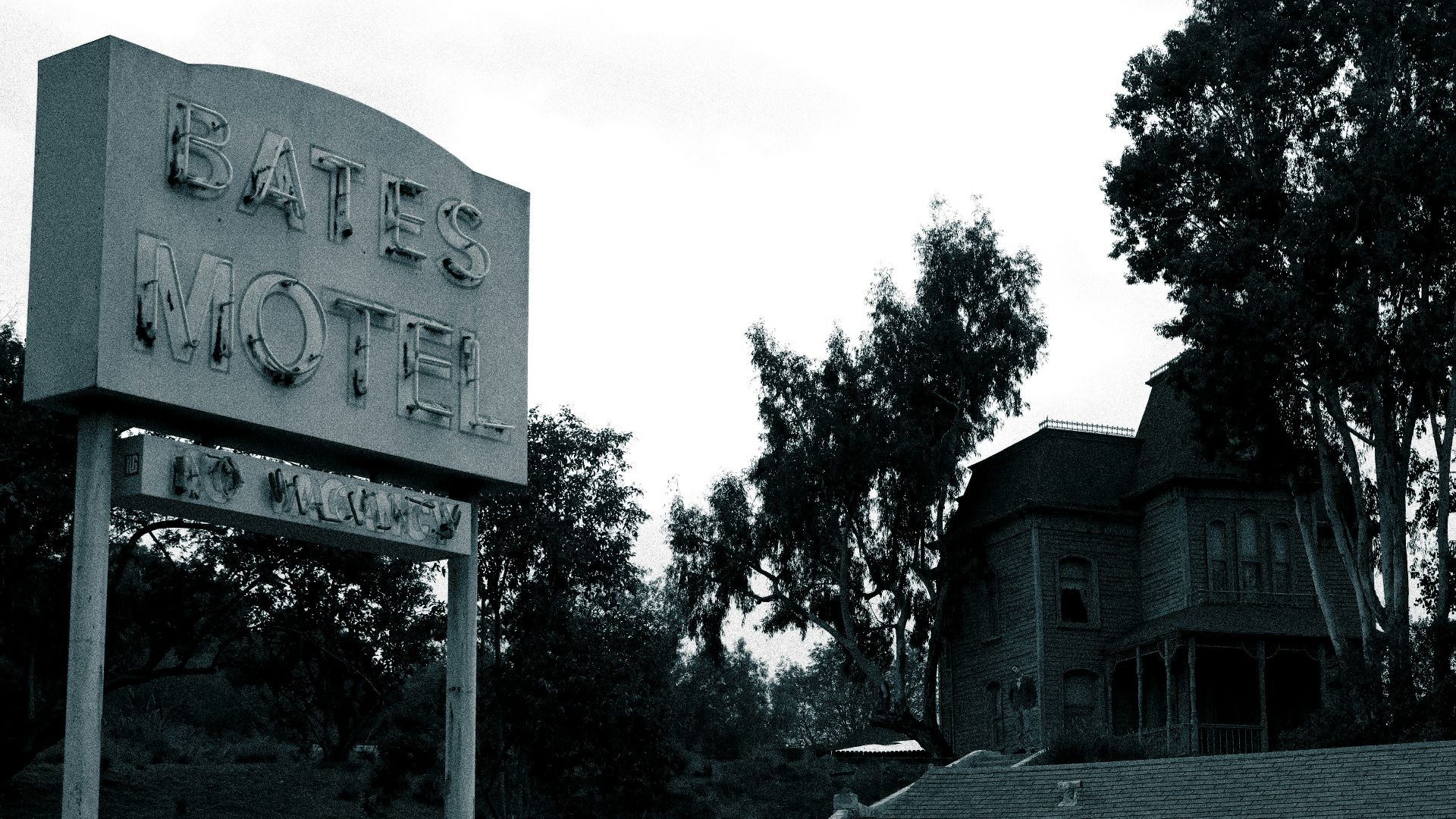an old car is parked in front of a motel