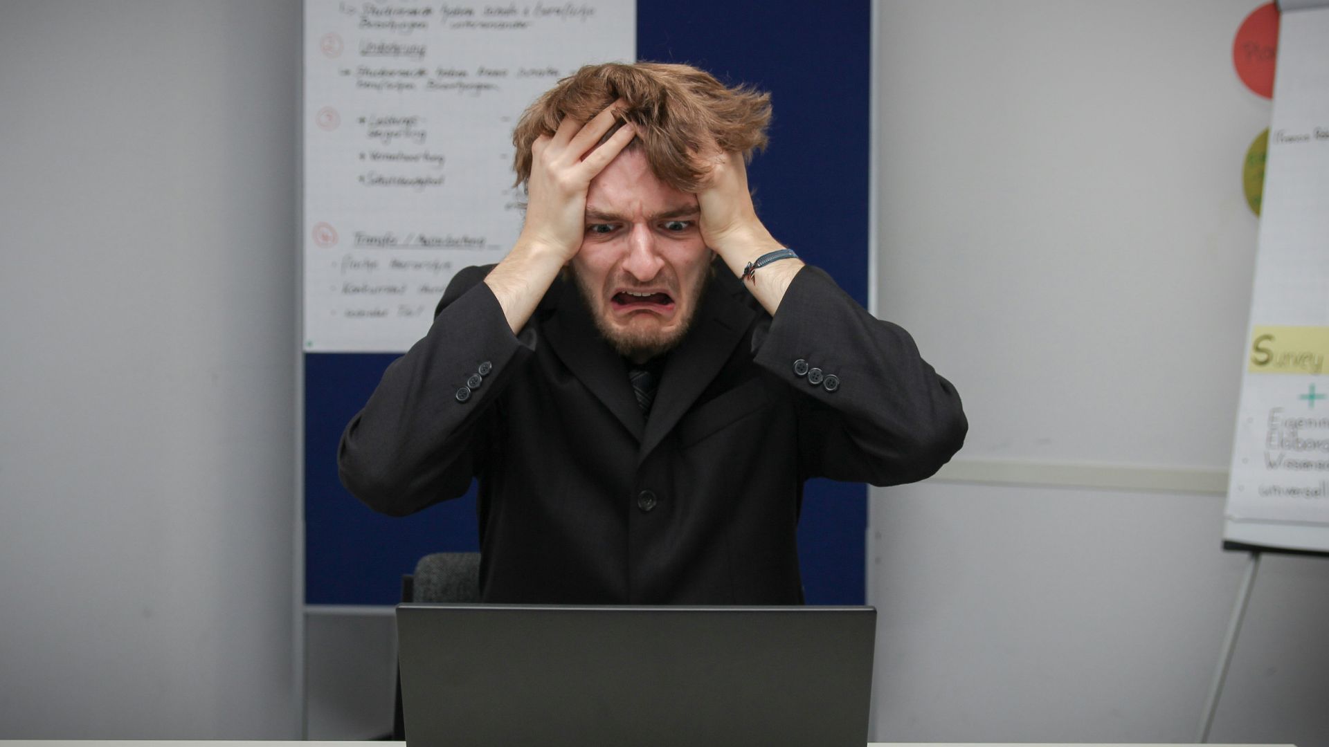 A man sitting in front of a laptop computer