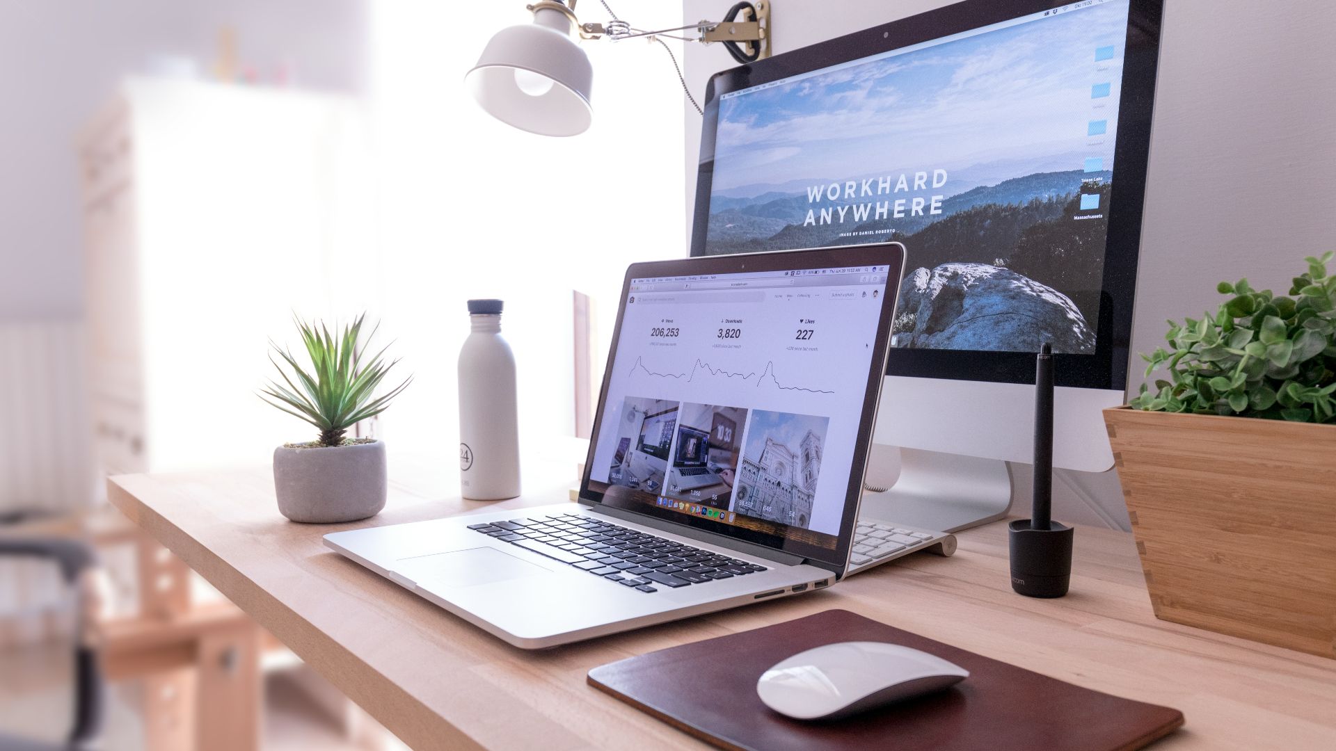 MacBook Pro on table beside white iMac and Magic Mouse