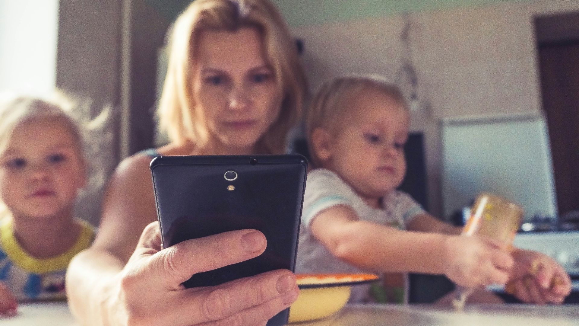 woman in white shirt holding black ipad