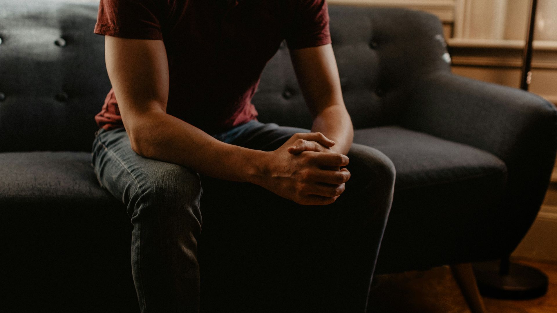man sitting on sofa