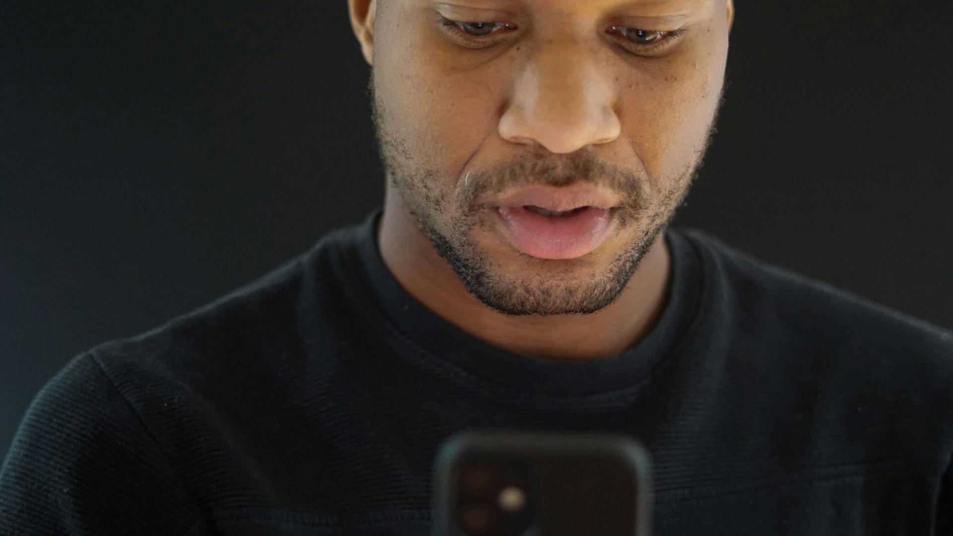 a close up of a person looking at a cell phone