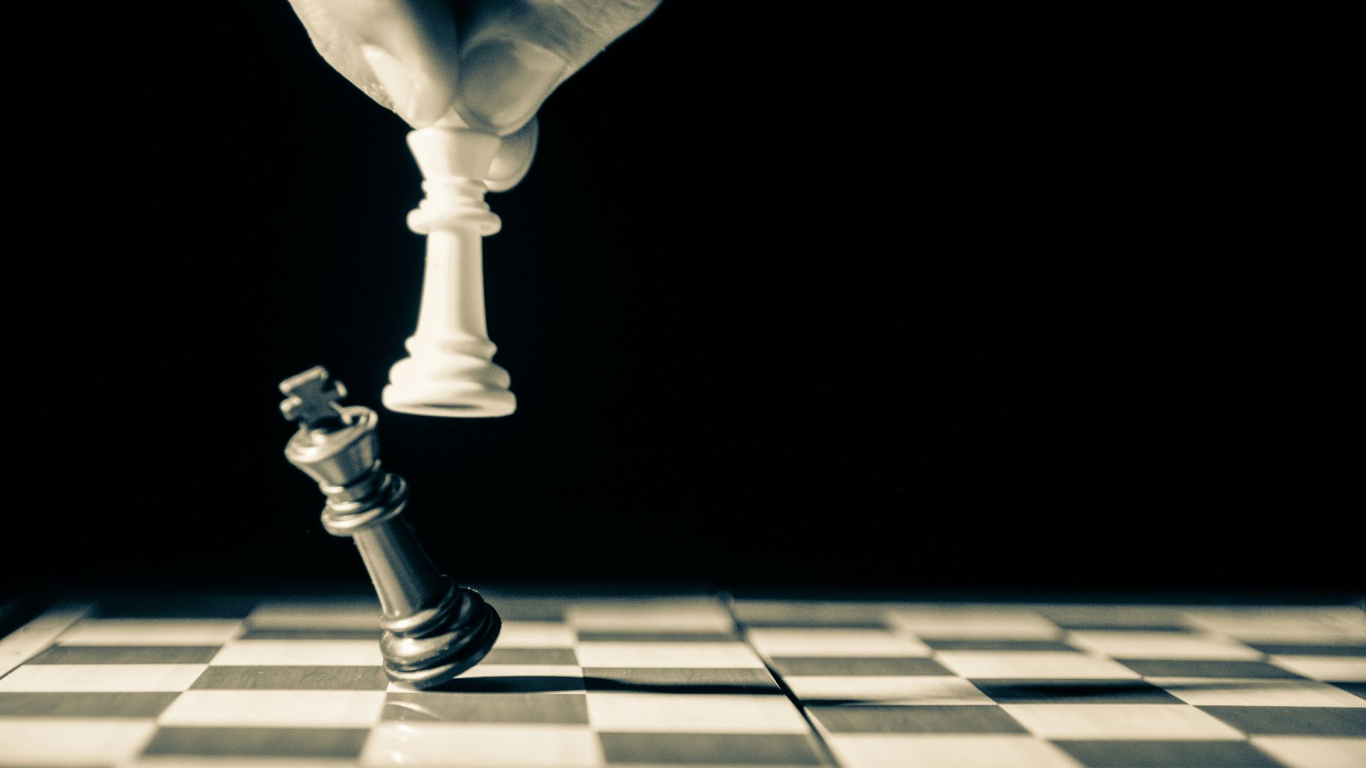 grayscale photo of person holding glass