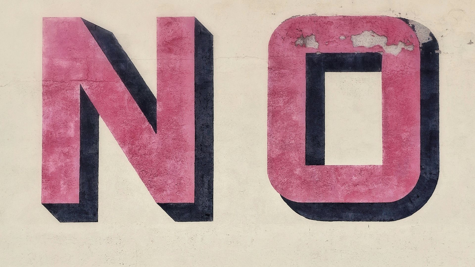 man riding bicycle beside wall with no text