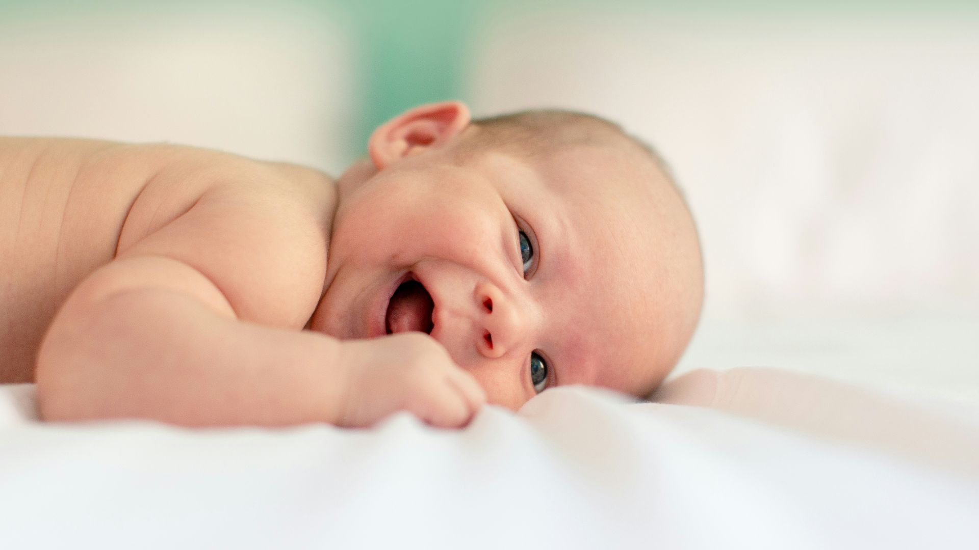 baby lying on fabric cloth