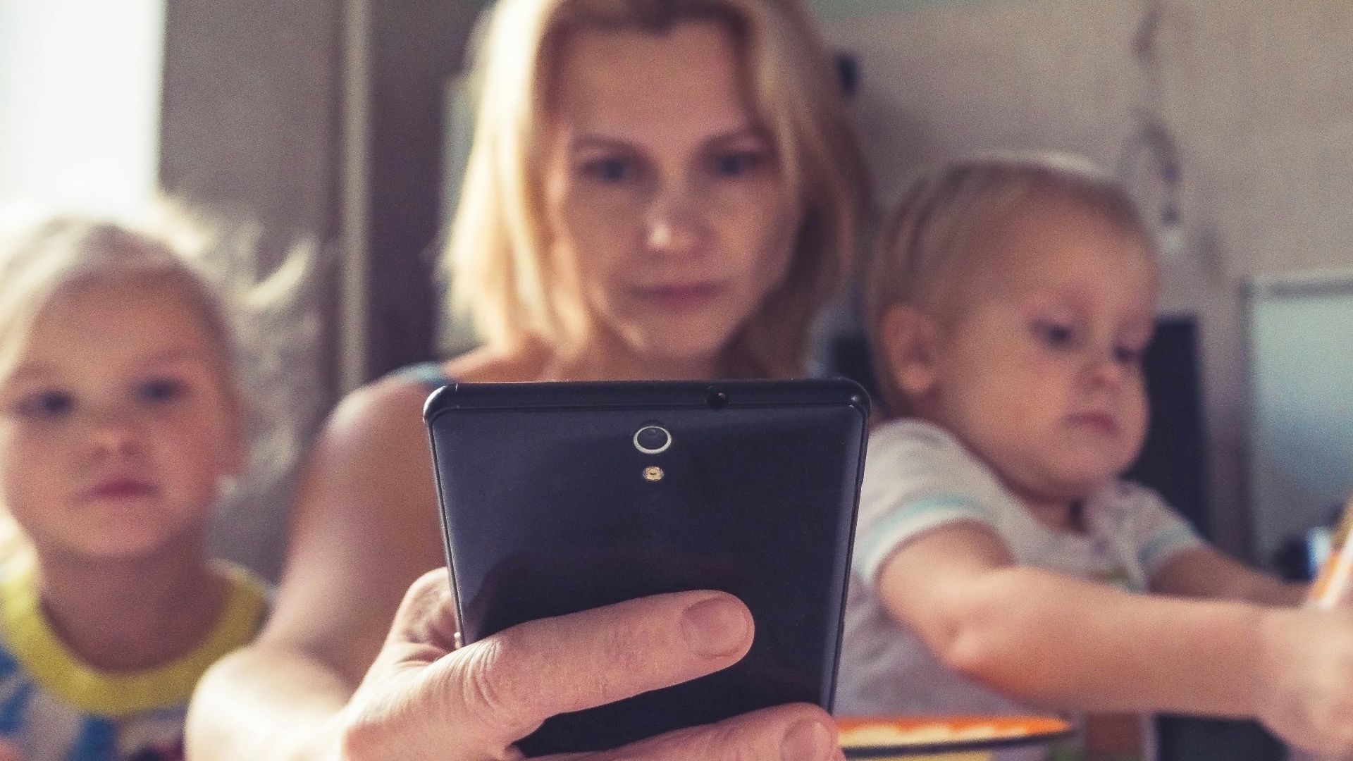 woman in white shirt holding black ipad