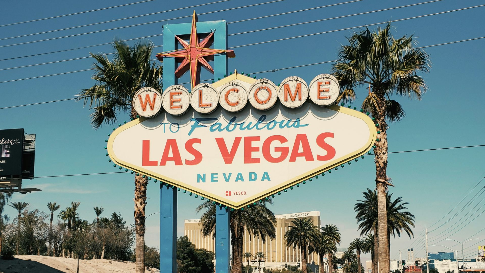 a sign on a street with Welcome to Fabulous Las Vegas sign in the background