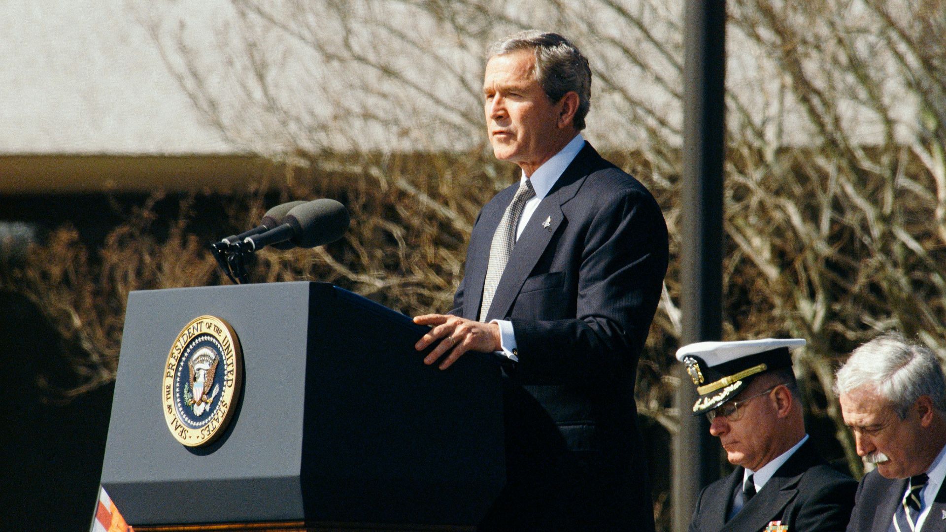 George W. Bush standing on lectern during daytime