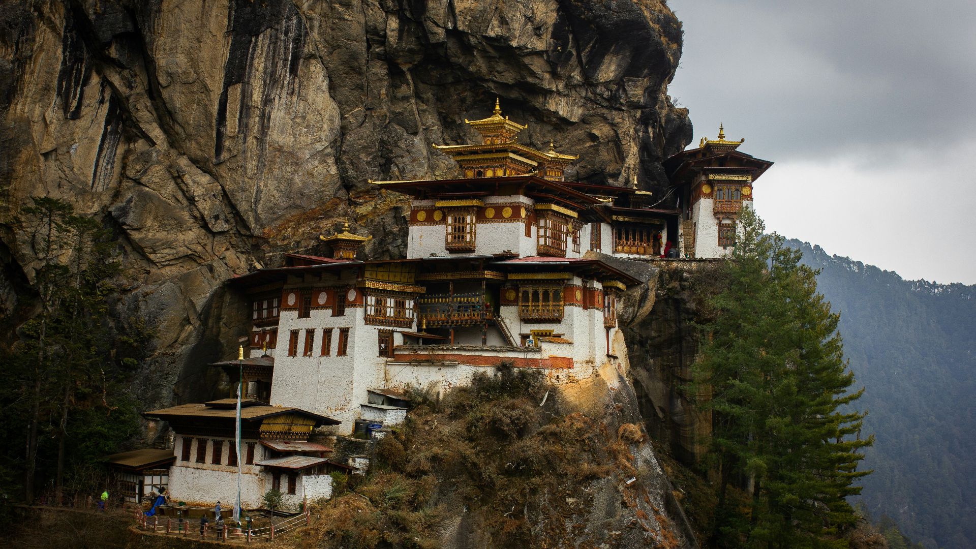 white and brown concrete house on rocky mountain during daytime