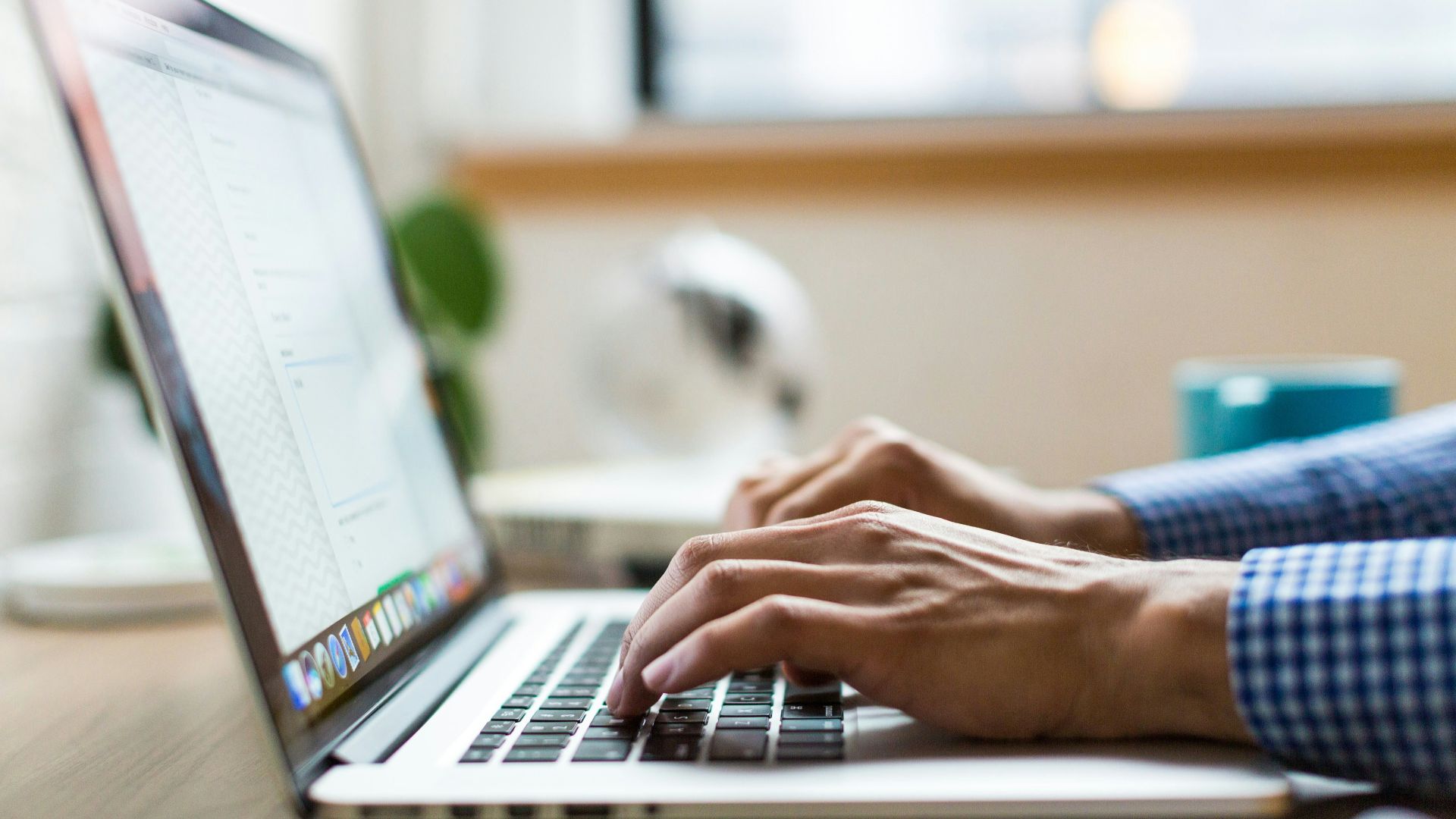 person typing on silver MacBook