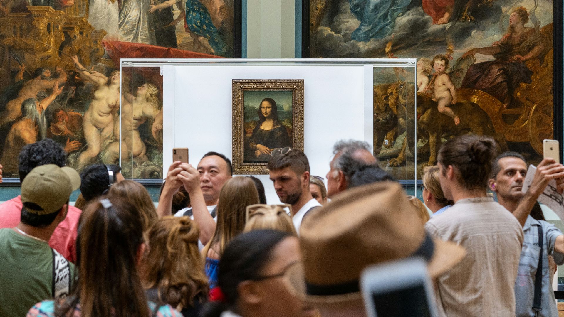people gathering near Monalisa painting