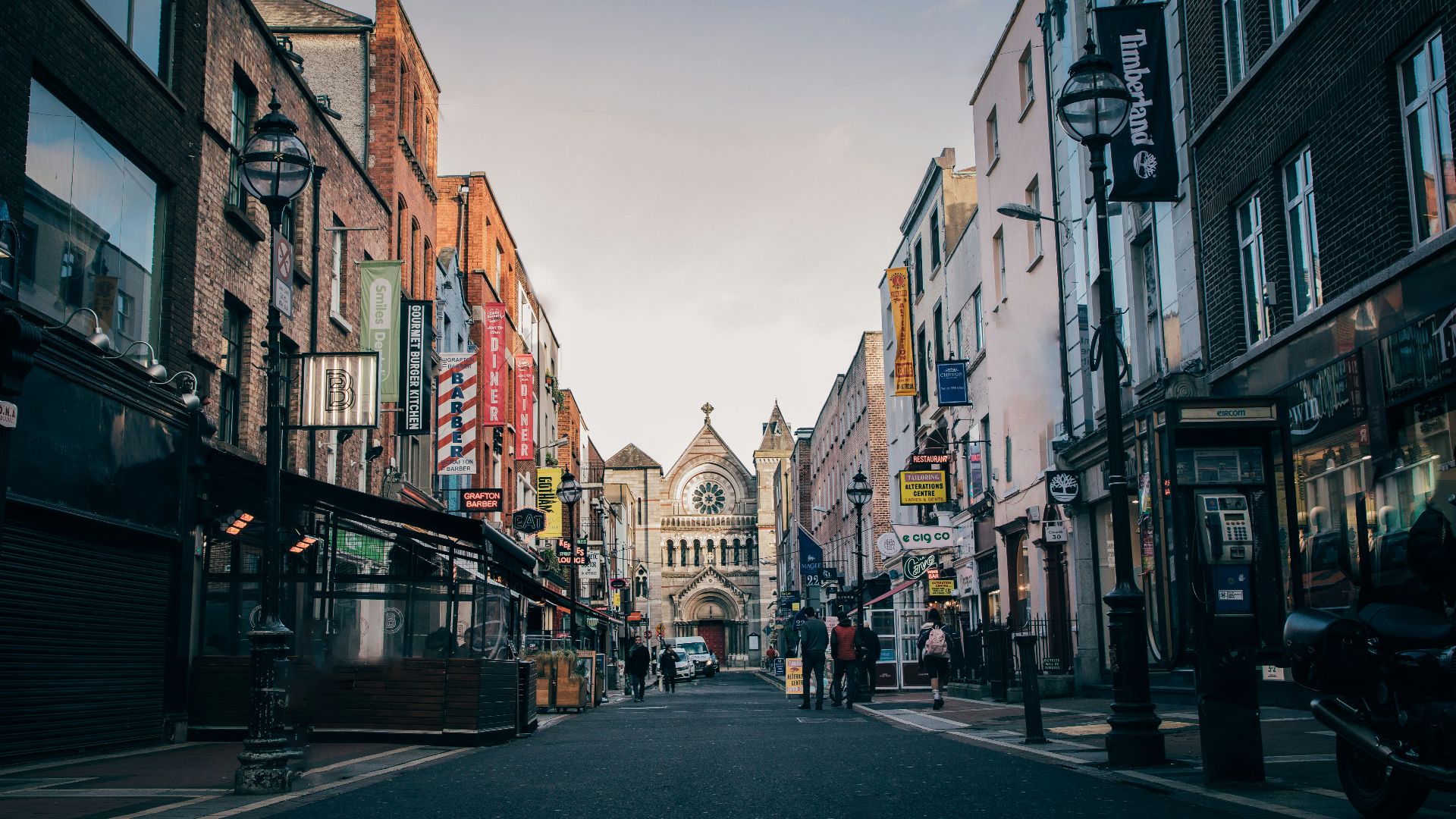 people walking on street heading towards church
