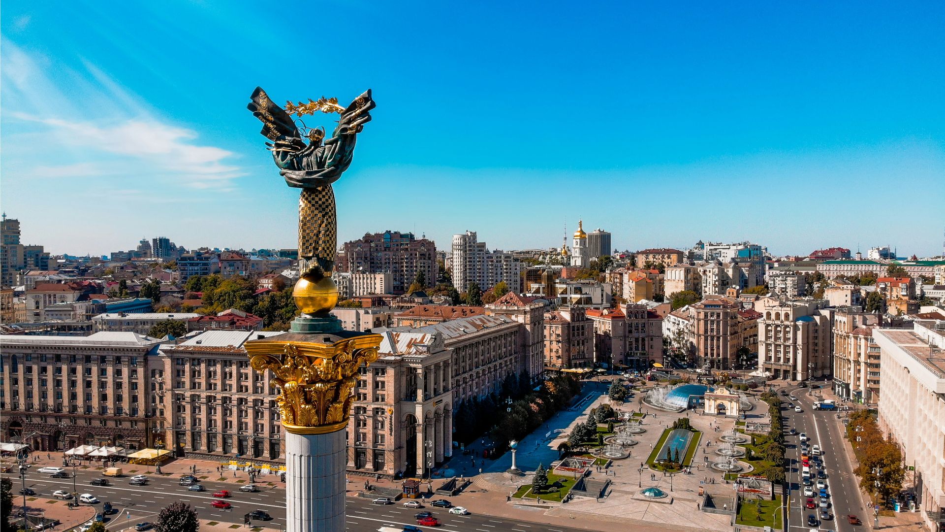 a view of a city with a statue in the middle