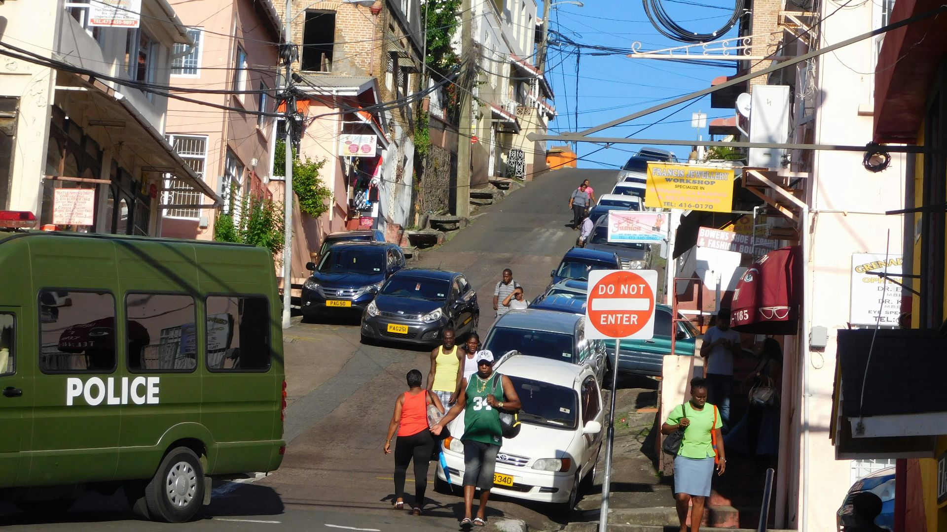 a group of people standing on the side of a road
