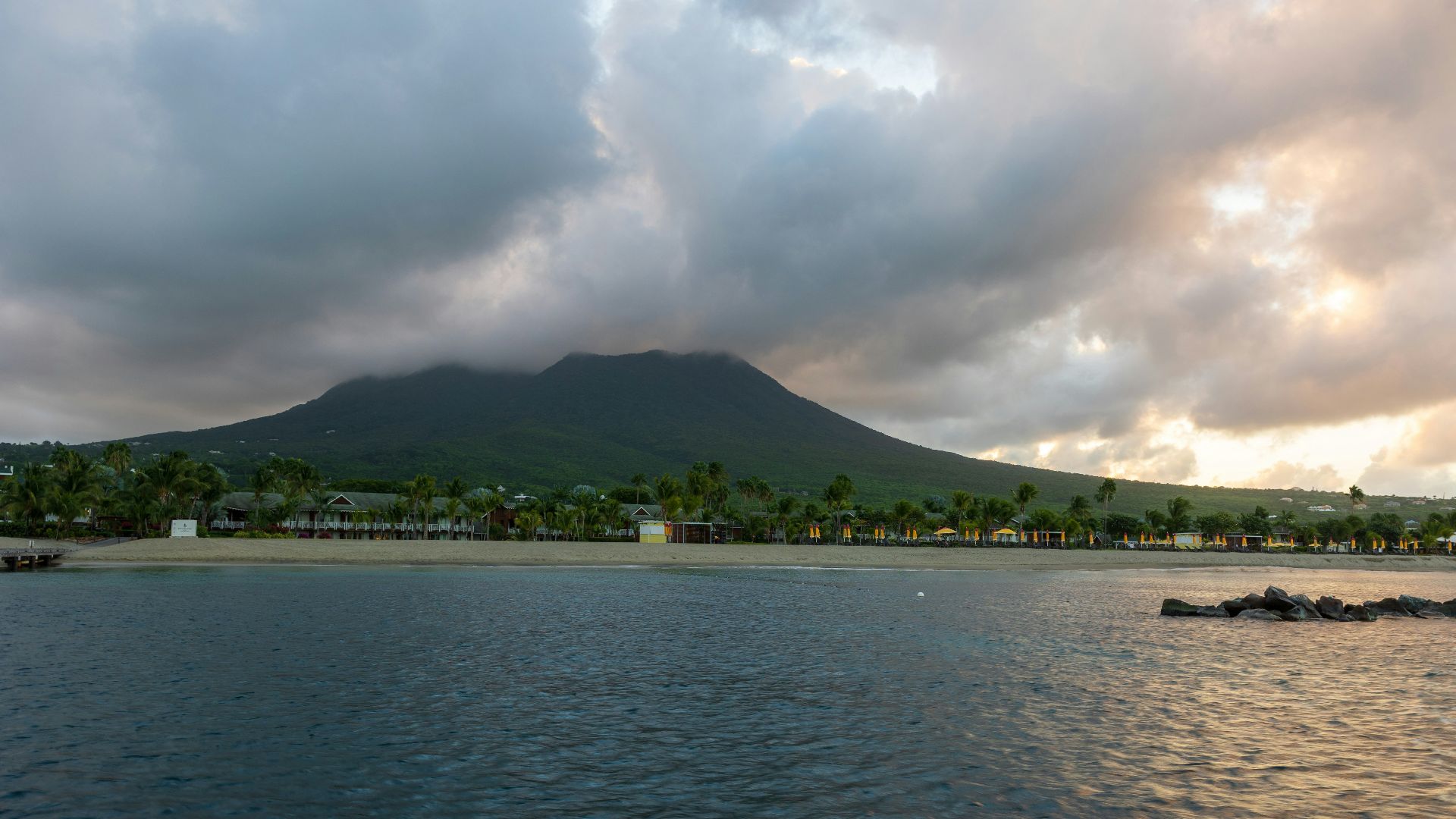 a large body of water with a mountain in the background