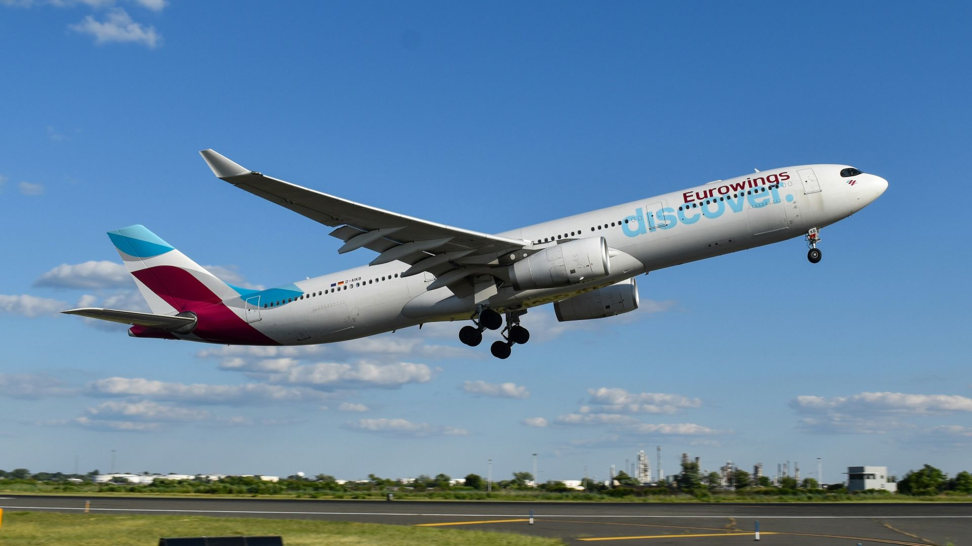 A large passenger jet taking off from an airport runway