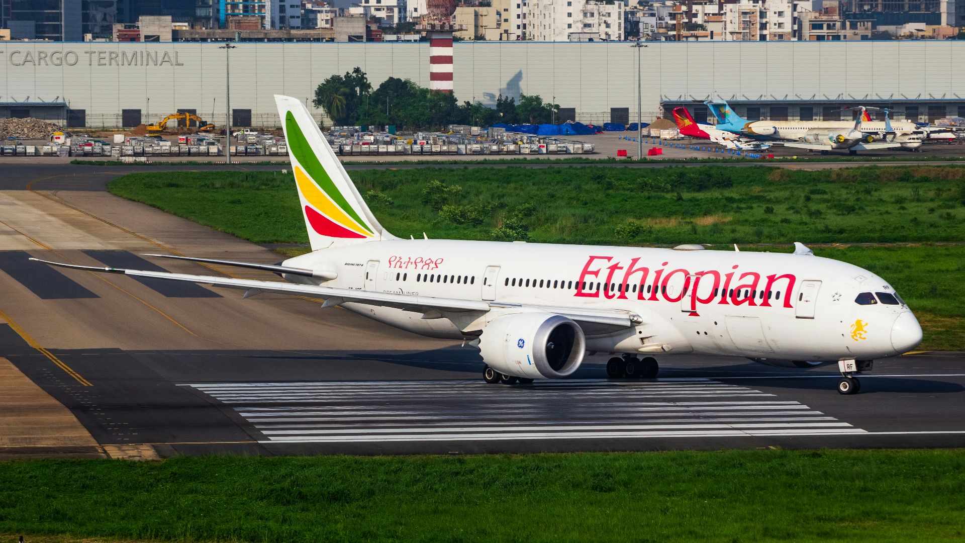 A large jetliner sitting on top of an airport runway