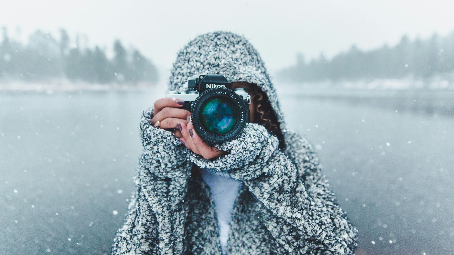 woman using Nikon DSLR camera