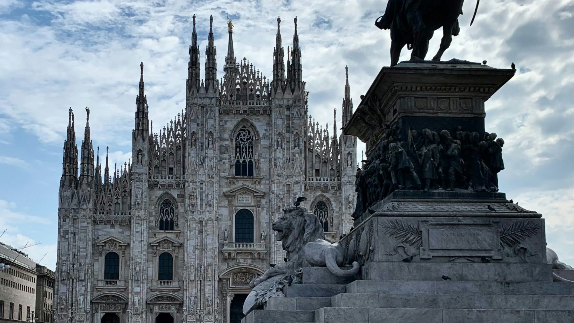 a statue of a man on a horse in front of a cathedral