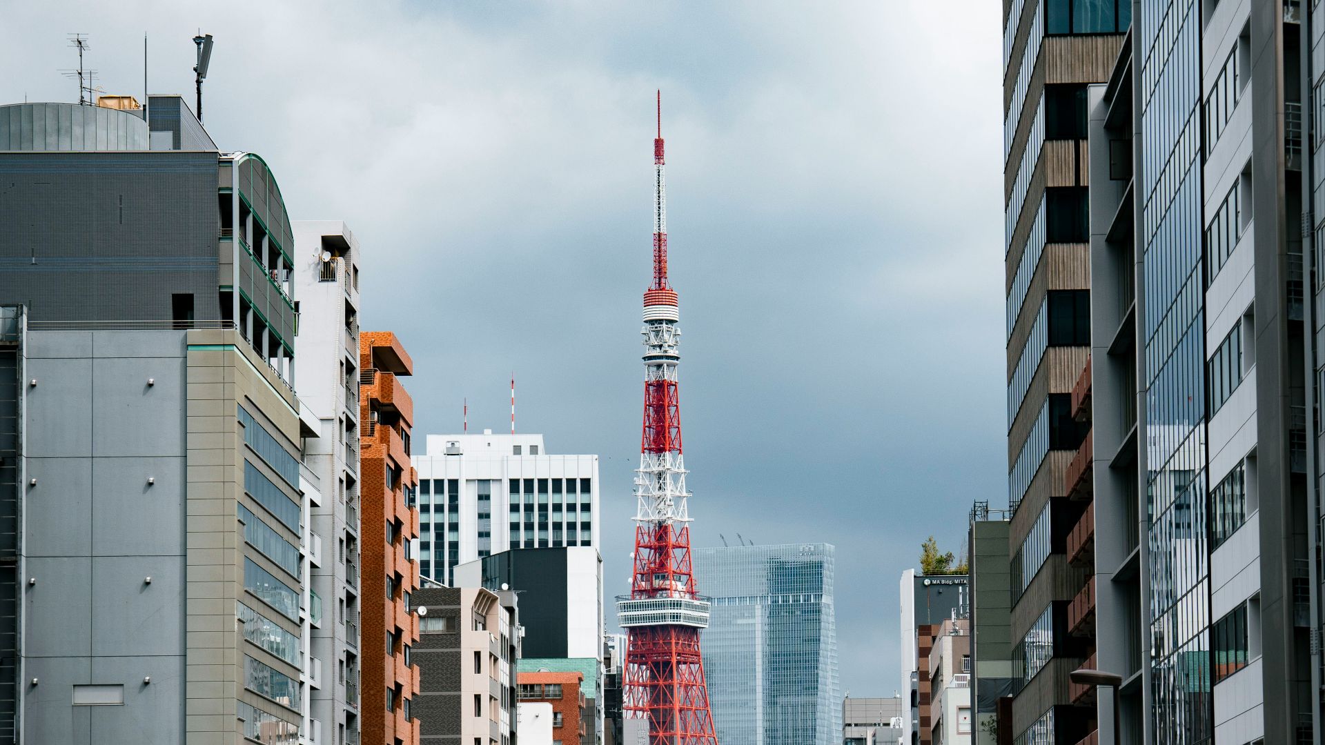 a city street filled with lots of traffic next to tall buildings