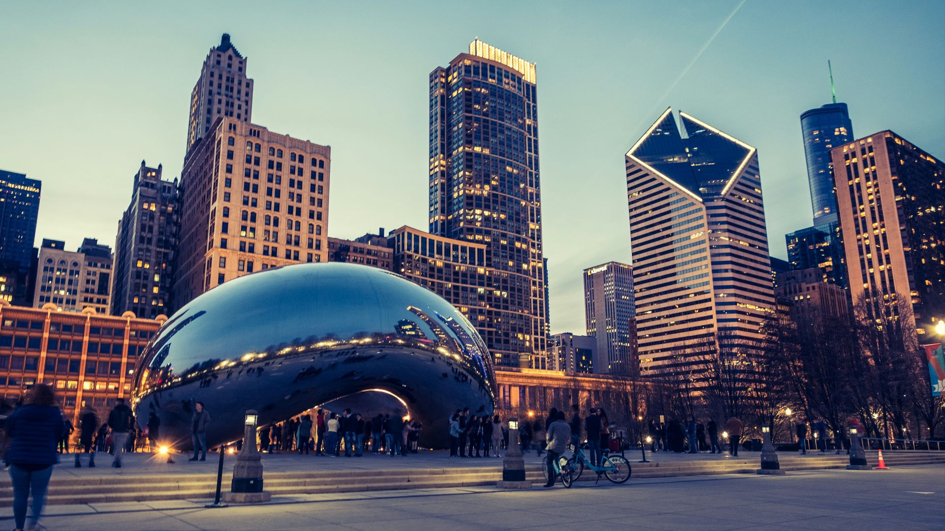 a group of people standing around a large metal object