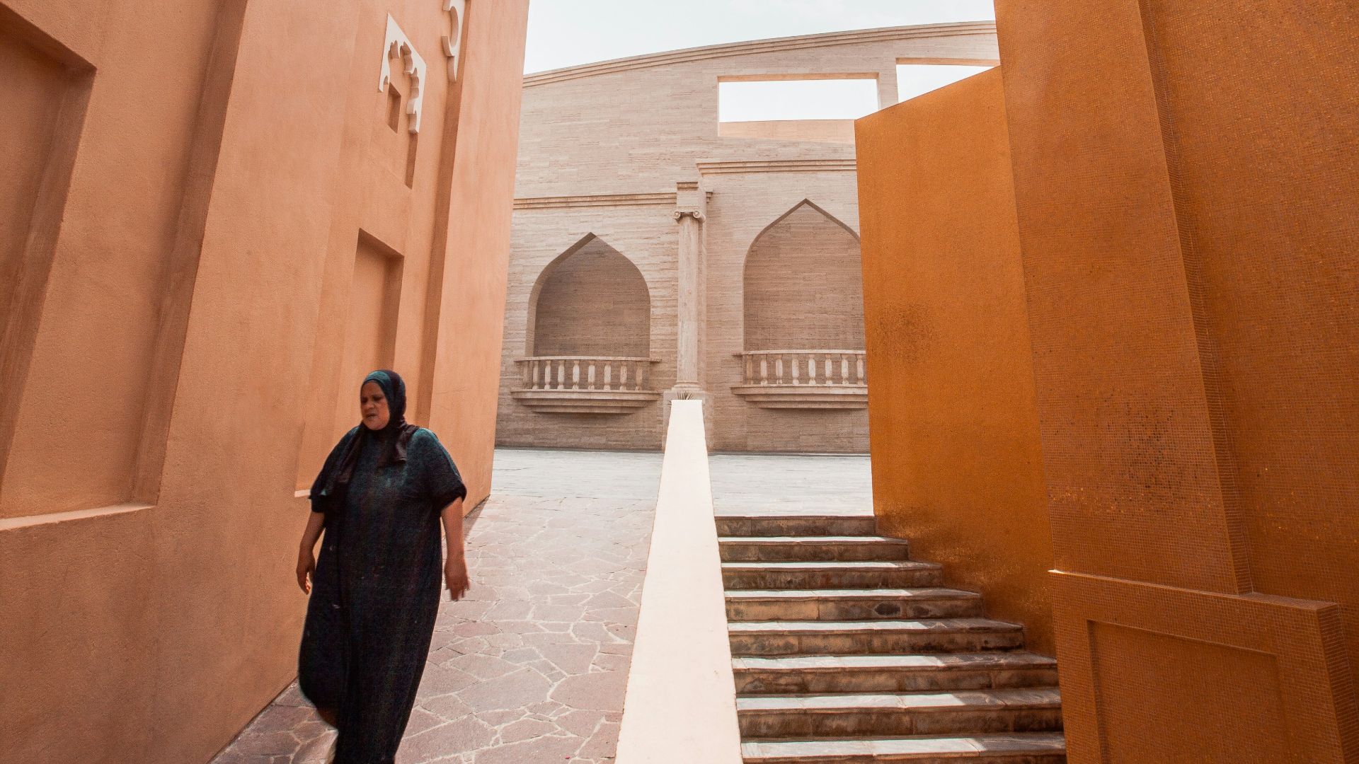 woman walking on sidewalk