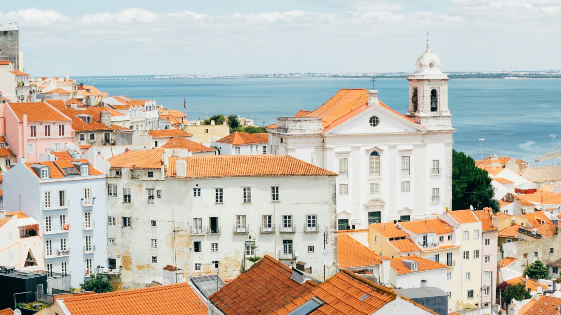 landscape photography of orange roof houses near body of water