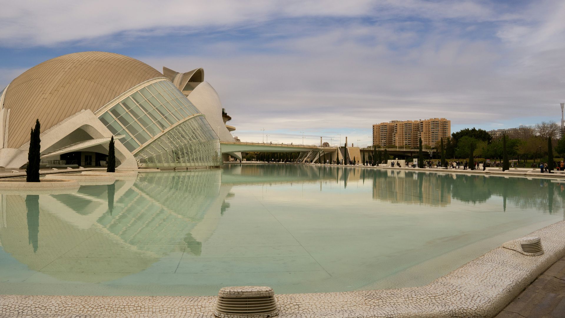 a large building sitting next to a pool of water