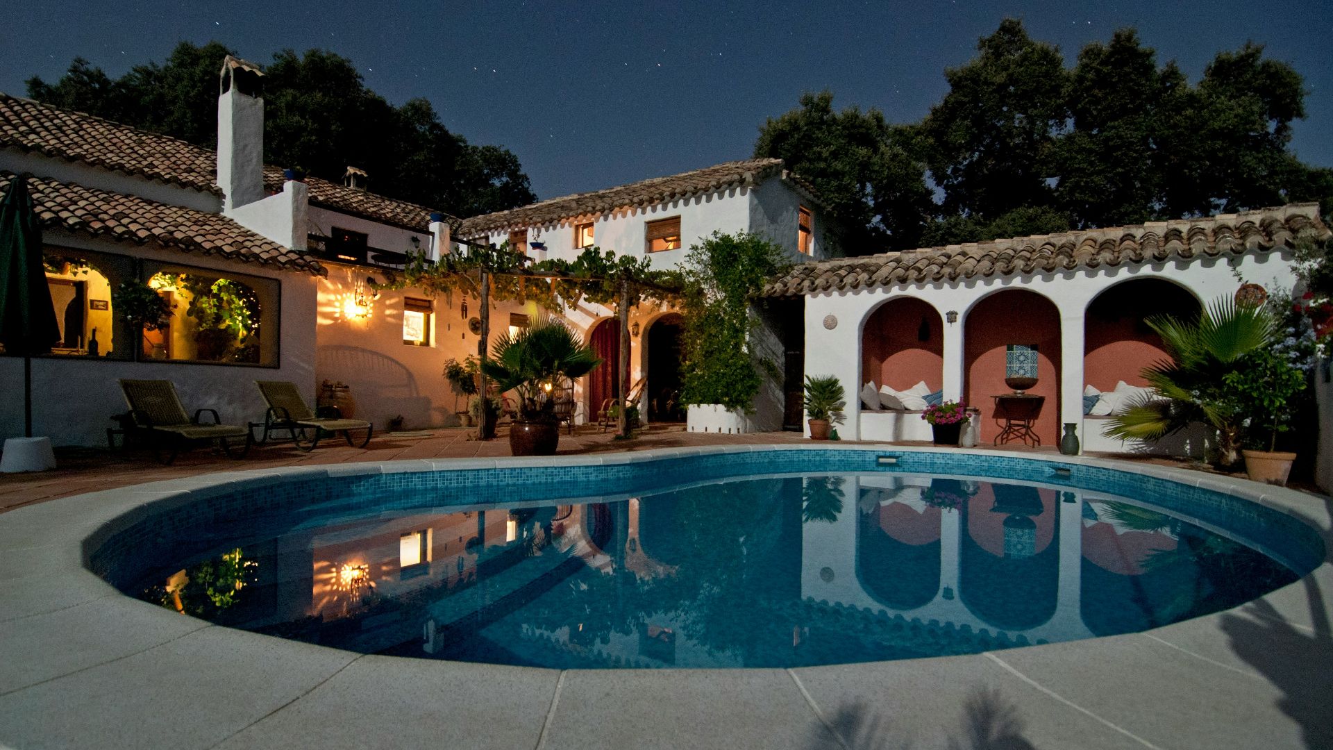 white concrete house surrounded by trees