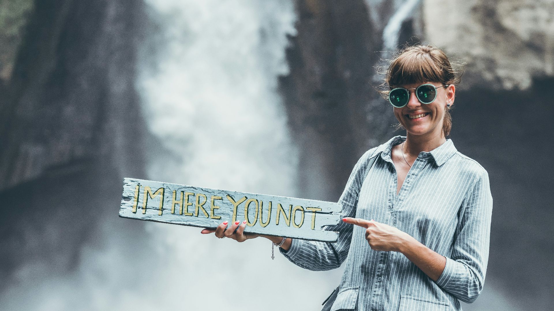 a woman holding a sign that says i'm here yount