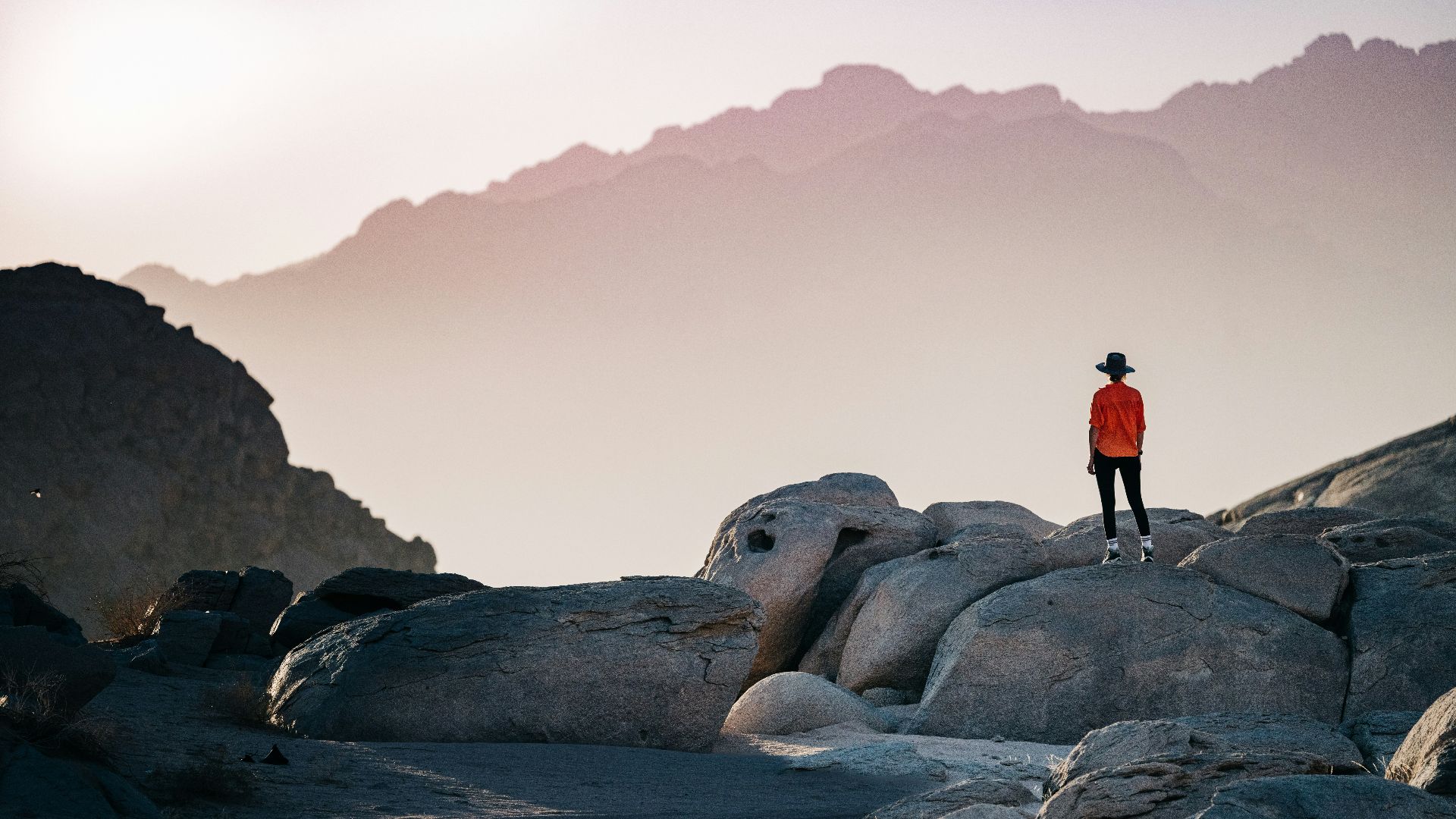 a person standing on top of a large rock