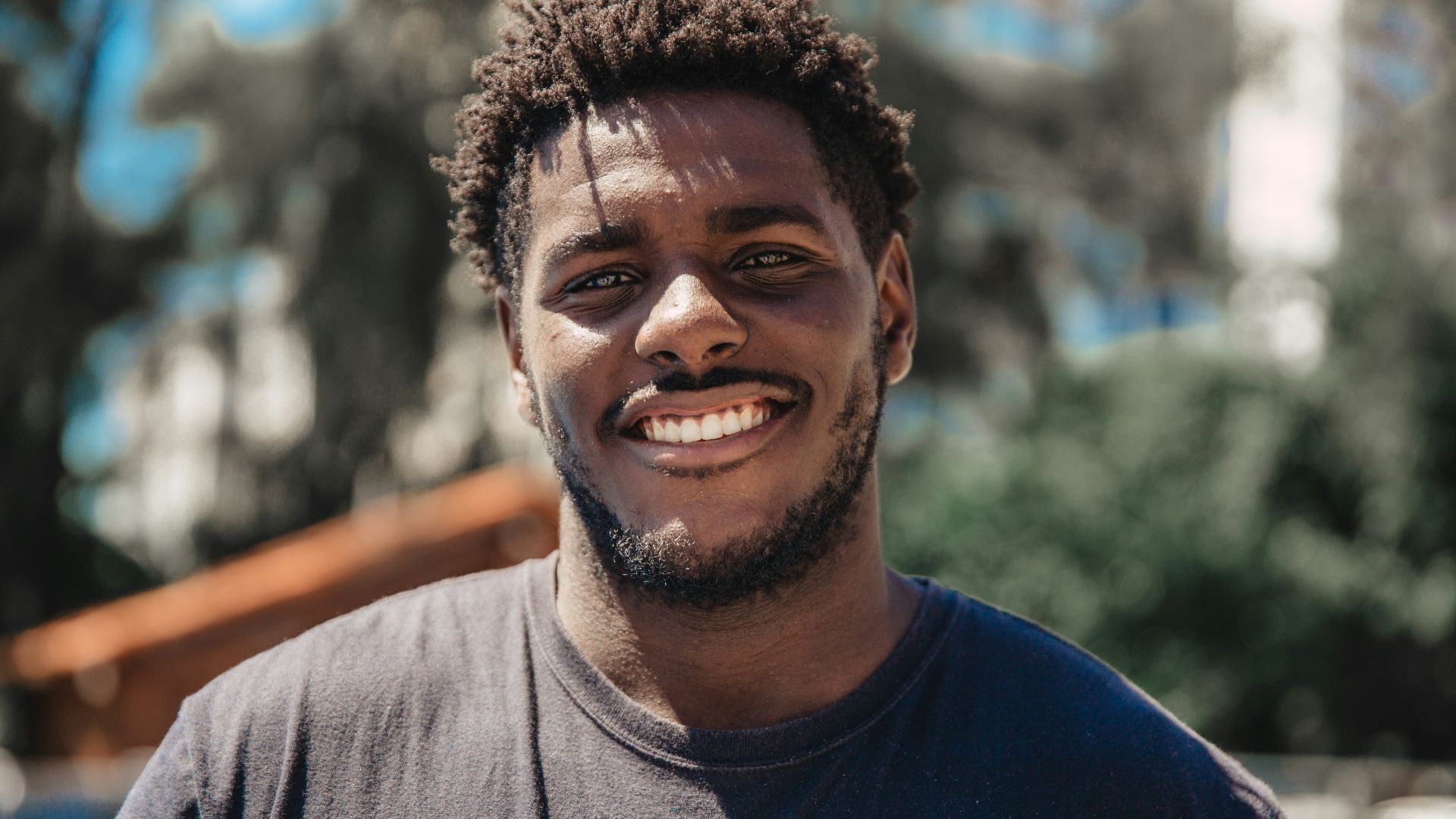 selective focus of man smiling during daytime