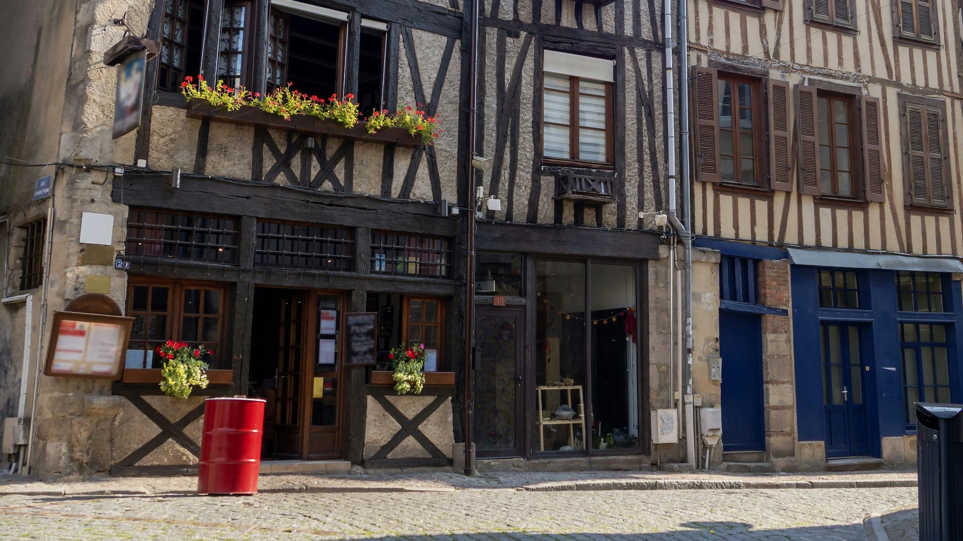 an old building with flower boxes on the windows