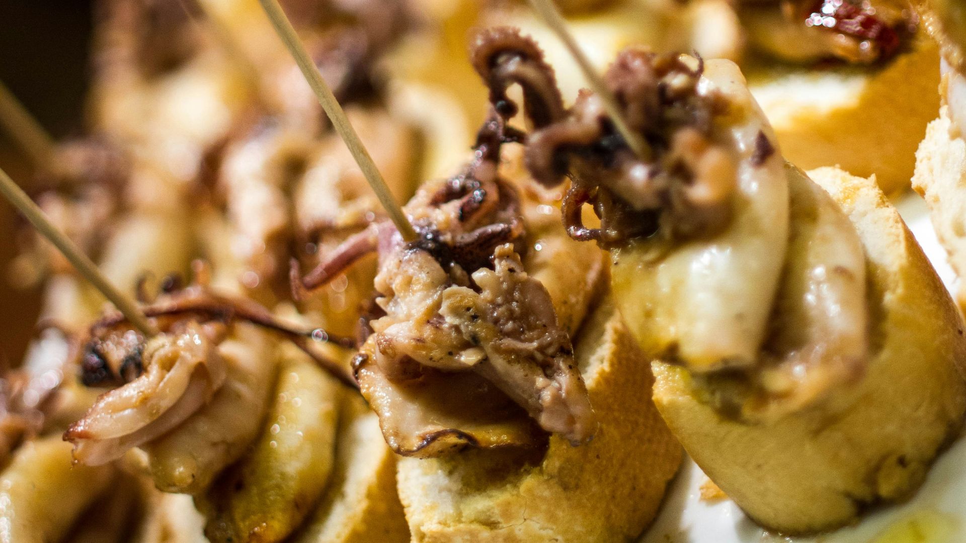 a close up of a plate of food with toothpicks