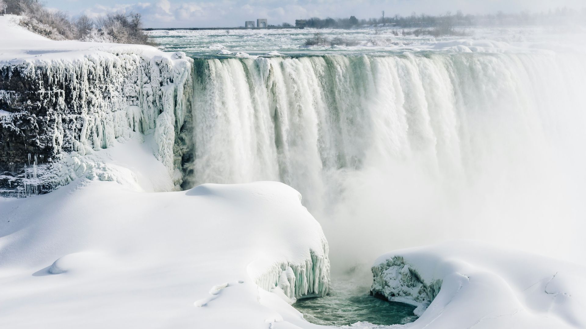 landscape photo of waterfall and snow during daytime
