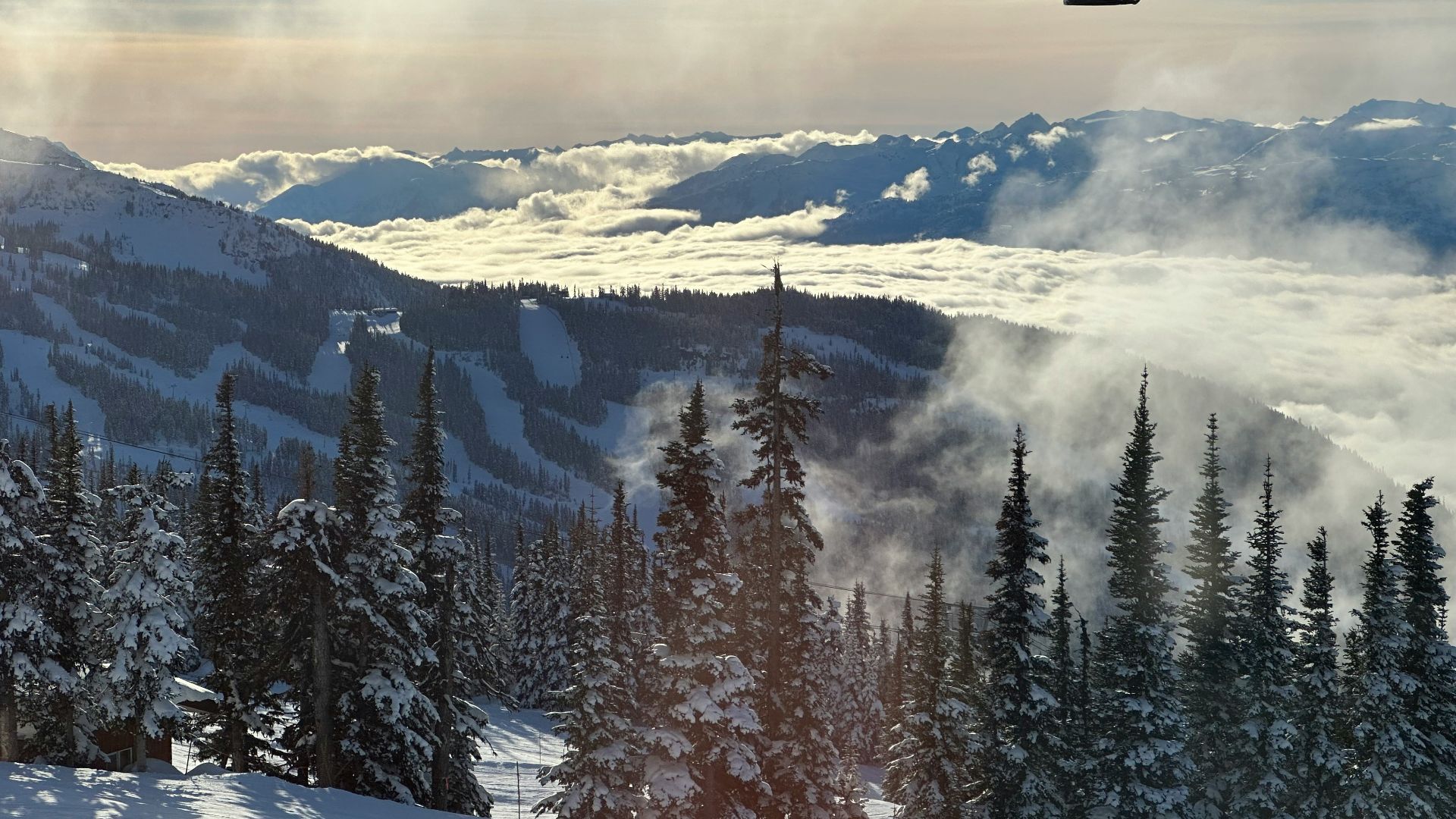 a ski lift going up a snowy mountain