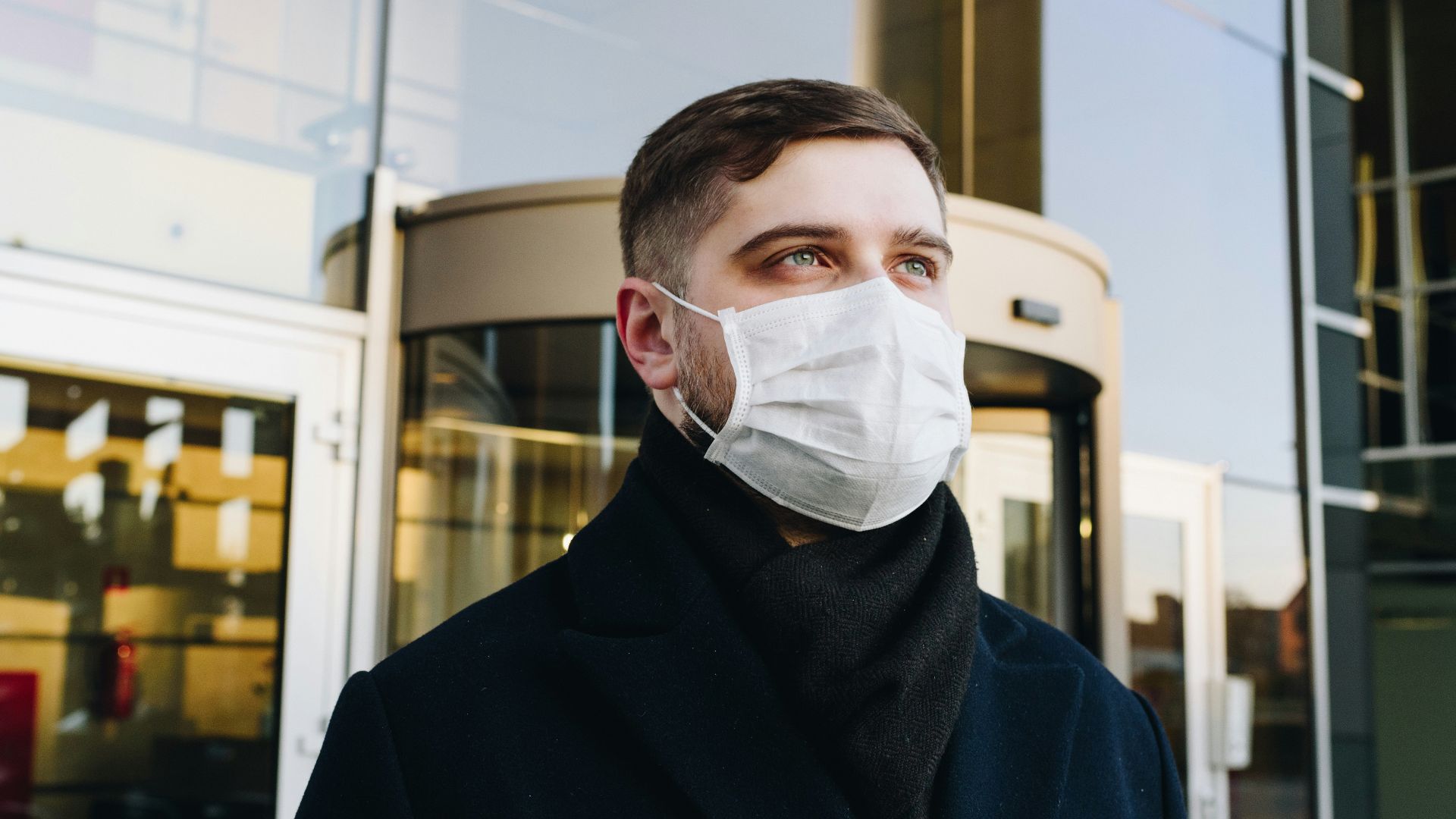 man in black robe wearing white face mask