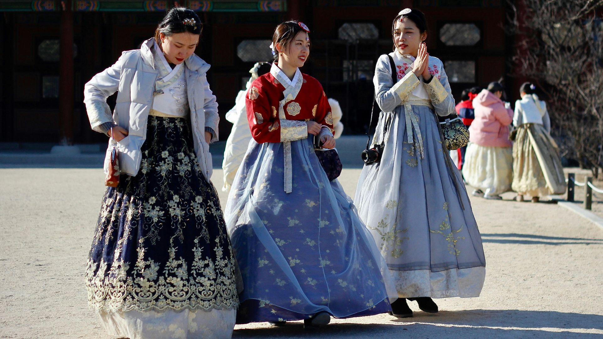 woman wearing white and black dress walking on street